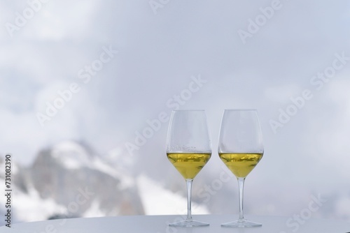 Toast with two glasses of white wine on the Mont Blanc glacier
