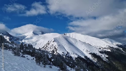 Beautiful Pirin mountains peaks covered with snow. Winter view at Bansko ski resort in Bulgaria photo