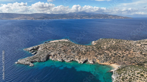 Aerial drone video of paradise beach and caves of Gerolimnionas in North part of small island of Schoinousa, Small Cyclades, Greece photo