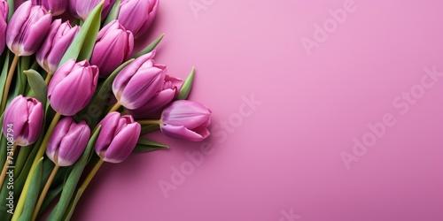 Bouquet of purple tulips on a pink background, top view, space for text. Generative AI © 22_monkeyzzz