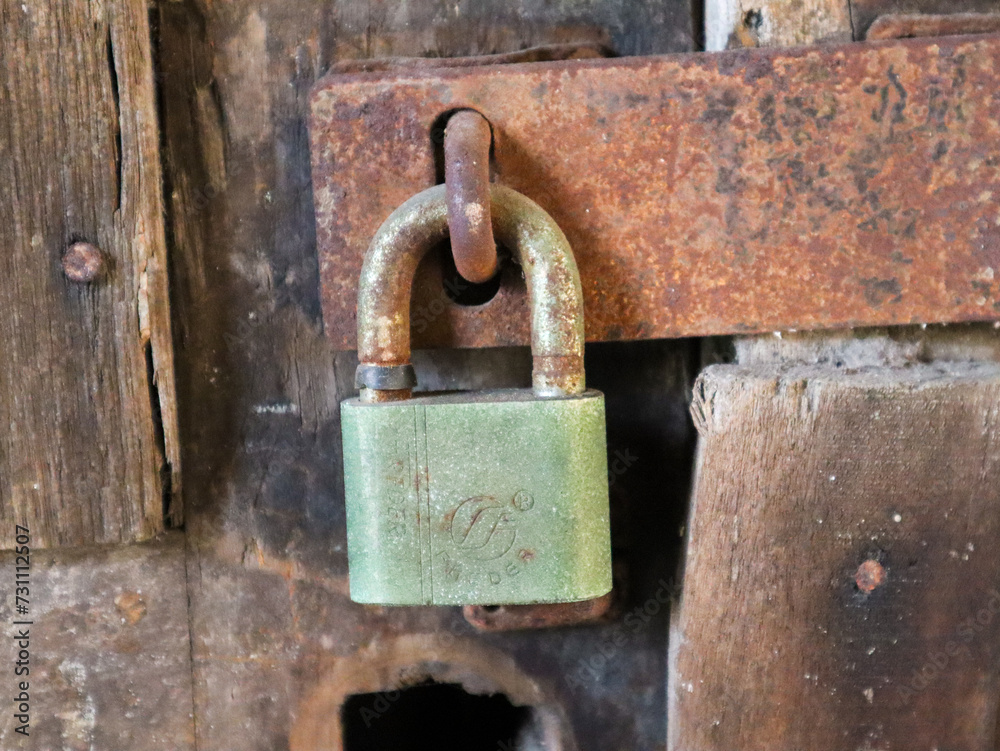 close up of the padlock locking the door. surabaya, indonesia - 4 january 2024 close up of the padlock locking the door. surabaya, indonesia - 4 january 2024