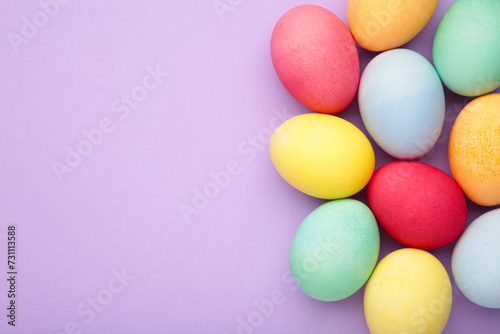 Multi color eggs on purple background.