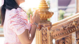 Asian woman to pay respect to Buddha statue in thailand.