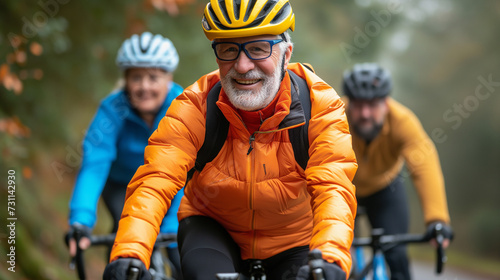 Retired group of elderly people cycling outside in bright safety gear.