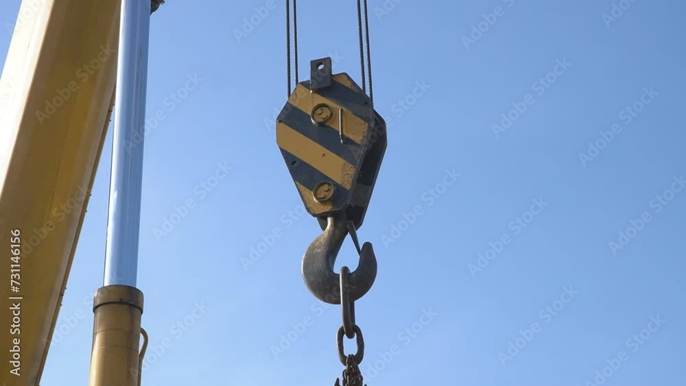 Mobile crane with hook and straps is raising work platform, basket. Mobile crane with hook and straps is raising work platform, basket.