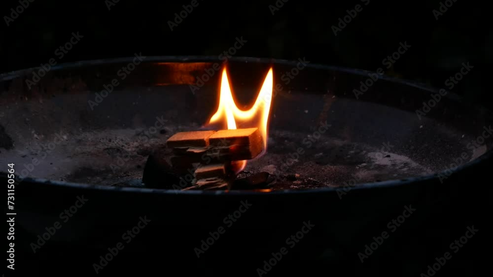Lighting the fire to start the embers for barbecue Lighting the fire to start the embers for barbecue