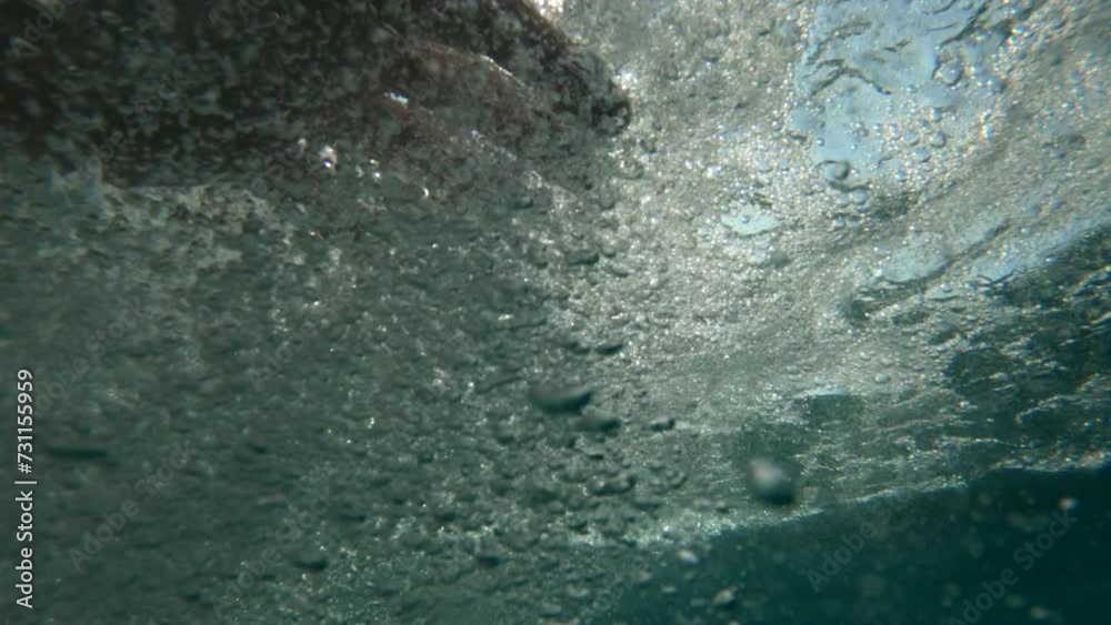 Underwater pov shot of male hand in water during swimming exercise Underwater pov shot of male hand in water during swimming exercise