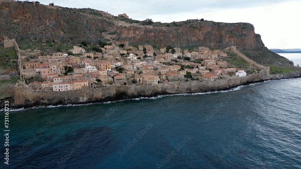Europe,Greece , Laconia - Monemvasia is a  tied island tourist attraction summer destination in  east coast of the Peloponnese - drone arial view of fortified city with walls by the sea