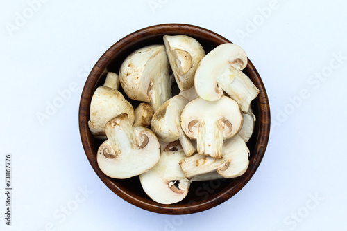 Sliced White mushrooms in a wooden bowl 