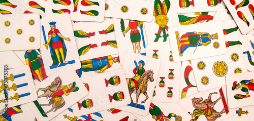 Spanish-suited playing cards. The Neapolitan pattern widely used in central and southern Italy. Zenith view on bulk playing cards. Ideal for background or backdrop. Card games. photo