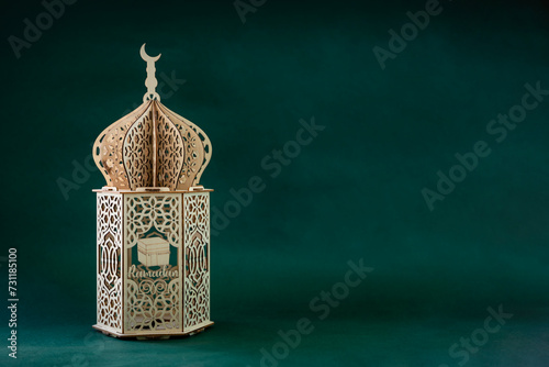 Vintage lantern lamp isolated on green colour background with copy space for greeting text, Ramadan Kareem and Eid Mubarak greeting poster design