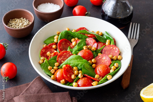 Salad with spinach, sausage, tomatoes and chickpeas. Healthy eating. Diet.
