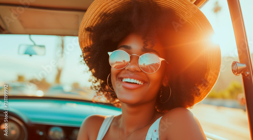 cheerful african american woman smiling while travelling in car