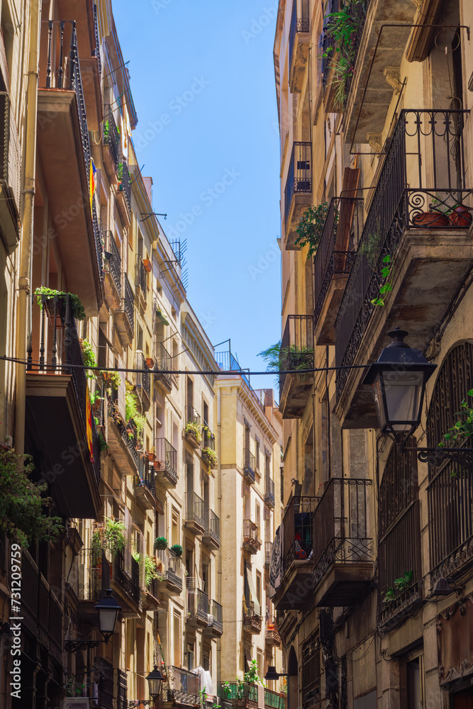Traditional Barcelona Historic Center buildings with iron balconies and road lanterns in Catalonia Spain.