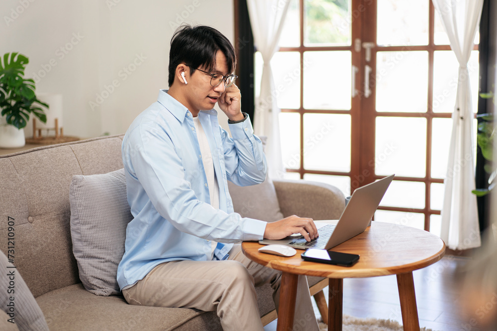 Businessman in casual is sitting comfortable sofa and wearing headphones to explaining business information