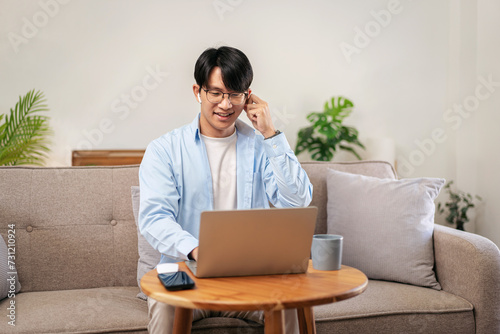 Businessman in casual is sitting comfortable sofa and wearing headphones to explaining business information photo