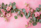 pink flowers leaves and eucalyptus on pink background