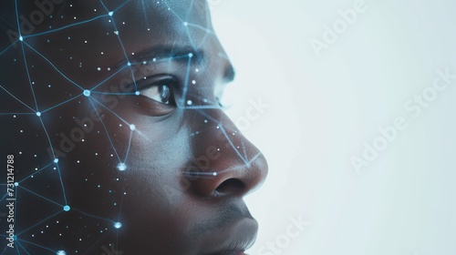 
A biometrical scan is reading the facial identification of a man as he unlocks access against a white background photo