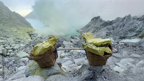 Baskets of sulpfur extracted from crater of Kawah Ijen volcano, Java, Indonesia photo