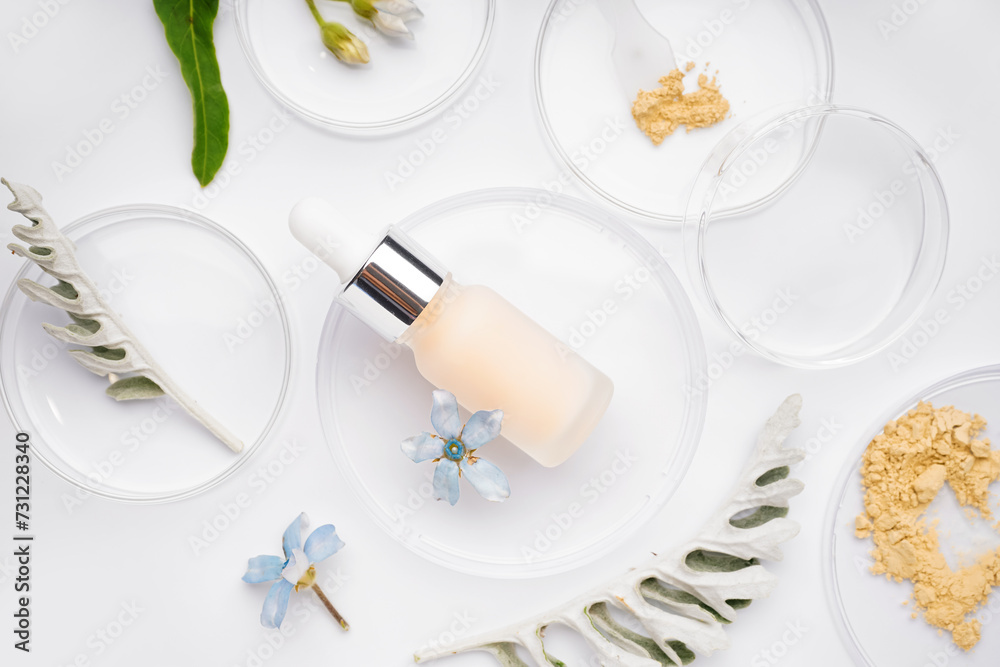 Petri dishes with sample, herbs and bottle of cosmetic product on white background Petri dishes with sample, herbs and bottle of cosmetic product on white background