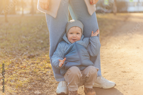 Happy family outdoor. Mother child on walk in park. Mom playing with baby son outdoor. Woman little baby boy resting walking in nature. Little toddler child and babysitter nanny having fun together