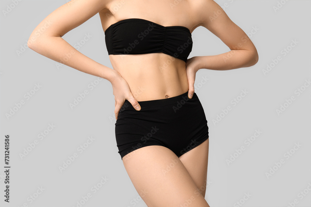 Sexy young woman in black underwear on light background Sexy young woman in black underwear on light background