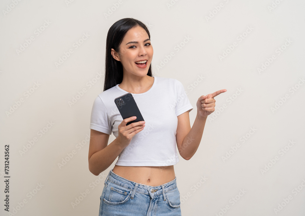 Attractive Pretty young asian woman using cellphone standing on isolated white background. Happy Excited Beautiful young asian shopping online payment with mobile phone. Playing game on smartphone Attractive Pretty young asian woman using cellphone standing on isolated white background. Happy Excited Beautiful young asian shopping online payment with mobile phone. Playing game on smartphone