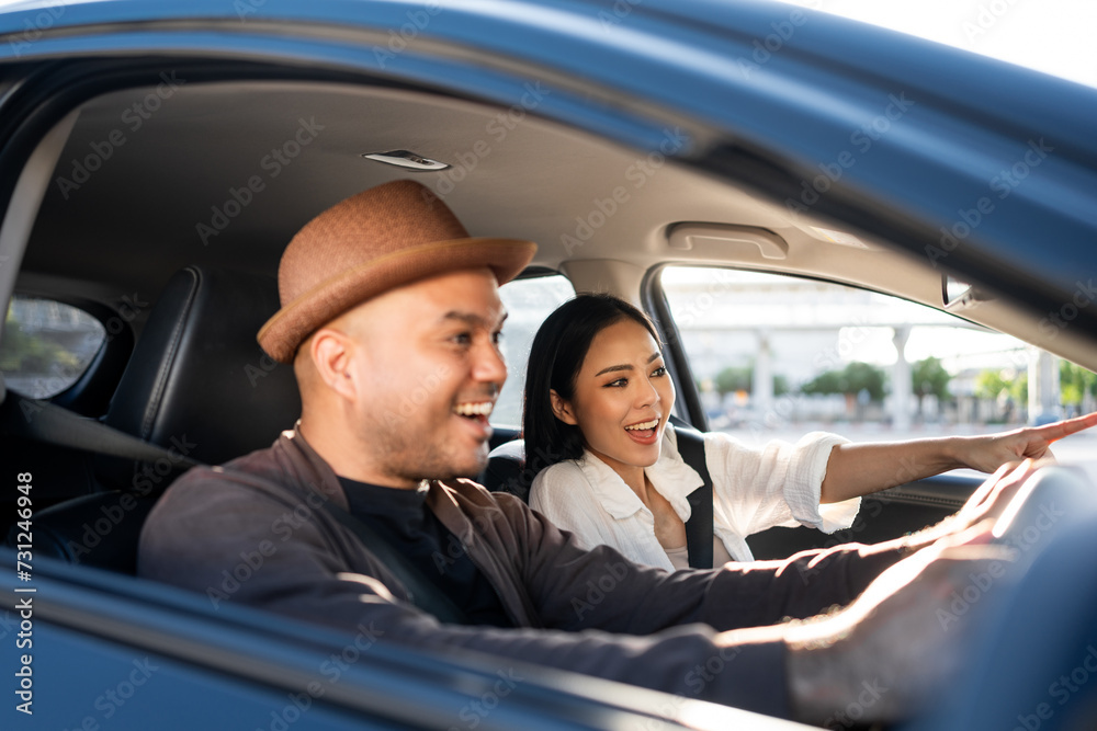 Young asian couple man and woman travel by car on a bright day beautiful blue sky sunlight. They was happy along the way trip. safety driving car vacation. Travel tourism vehicle. Young asian couple man and woman travel by car on a bright day beautiful blue sky sunlight. They was happy along the way trip. safety driving car vacation. Travel tourism vehicle.