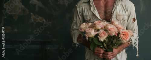 Romantic bouquet of pink roses held by a man, perfect for Valentine's Day promotions and wedding florist services.