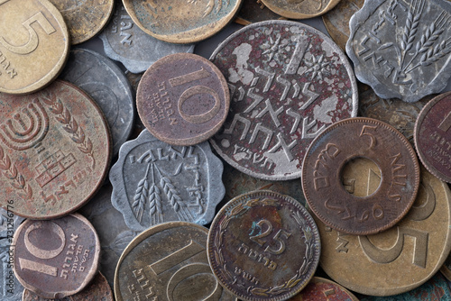 heap of old Israeli coins, including 25 agorot, reflects the historical currency of the past. These small denominations carry a legacy, representing a piece of Israel's monetary history
