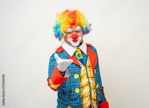 Mr Clown. Portrait of Funny comedian face Clown man in colorful uniform wearing wig standing pointing finger to camera. Happy expression amazed face male bozo in various pose on isolated background. photo