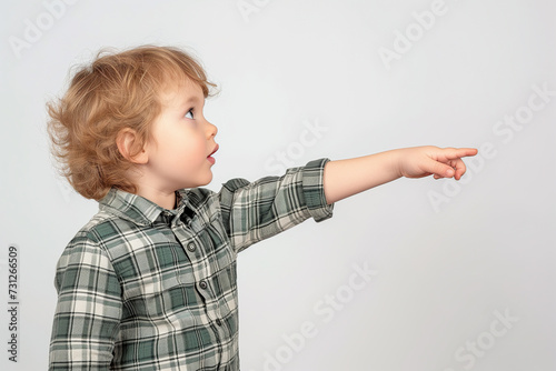 Boy in Green Plaid Shirt Pointing with Hand