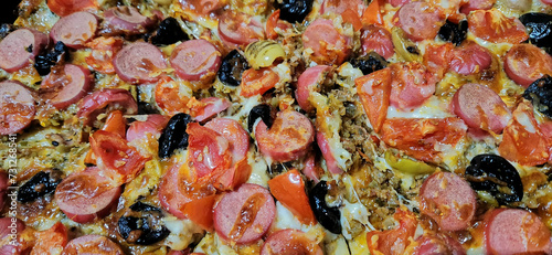 mixed pizza background with plenty of ingredients