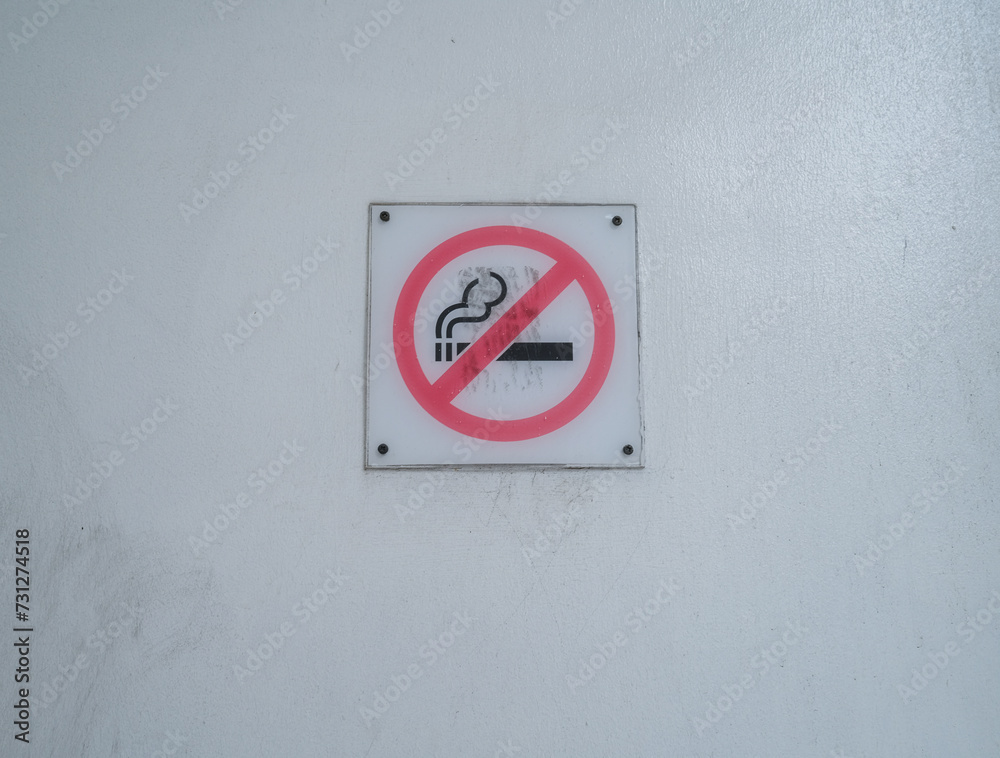 no smoking sign on a white wall at the subway station no smoking sign on a white wall at the subway station