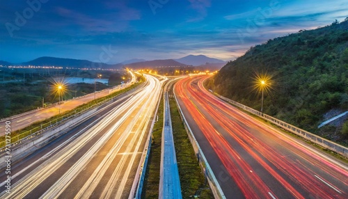 speed traffic light trails on motorway highway at night