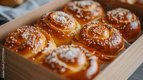 a box of freshly baked buns with powdered sugar