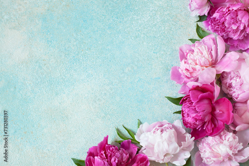 Pink and purple peonies flowers on a colored background for congratulations text