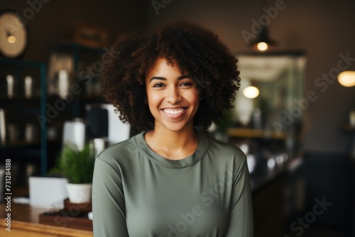 Smiling portrait of a young waitress in cafe or bar