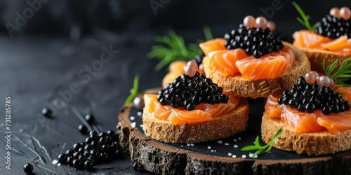 Gourmet Salmon and Caviar Appetizer. Elegant canapés with smoked salmon topped with sturgeon black caviar, copy space. photo
