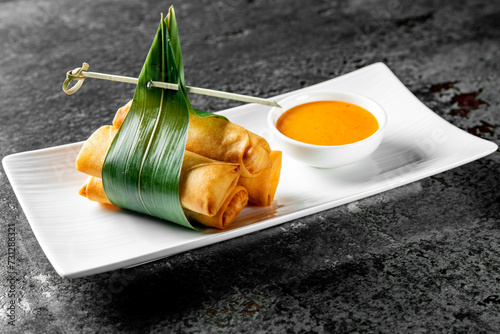 traditional vietnamese nems or deep fried spring rolls and dipping sauces photo