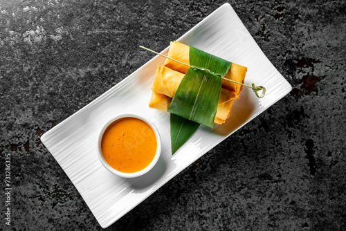 traditional vietnamese nems or deep fried spring rolls and dipping sauces photo