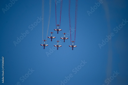 Airshow of aerobatic planes showcasing parachutes paramotor skydiving show with colors   photo