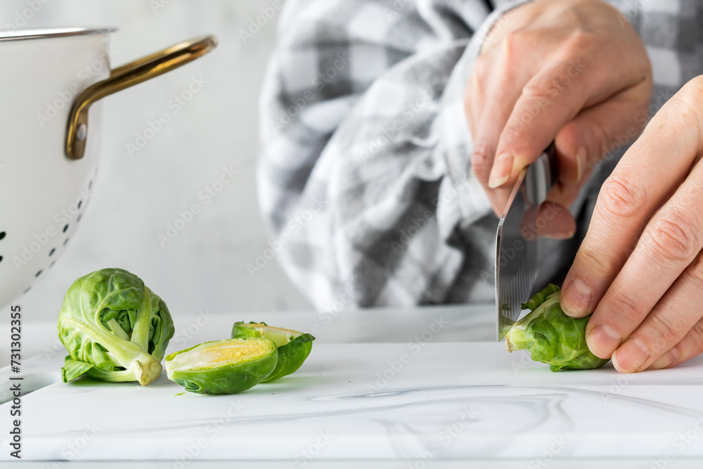 Preparing raw brussel sprouts for cooking. Preparing raw brussel sprouts for cooking.