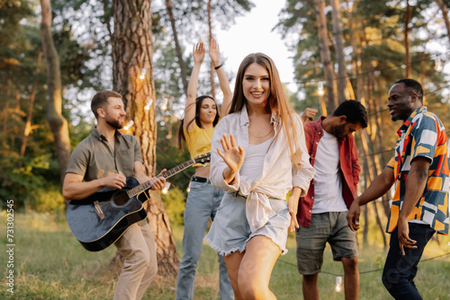 Multiracial group of people, beautiful hipster woman dancing on the background of friends having fun