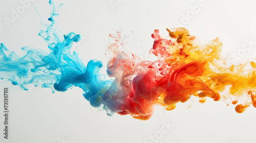 Red, blue, and yellow inks intertwine and diffuse in water, each creating its unique shape. The explosion of colors and fluidity characterize the abstract beauty