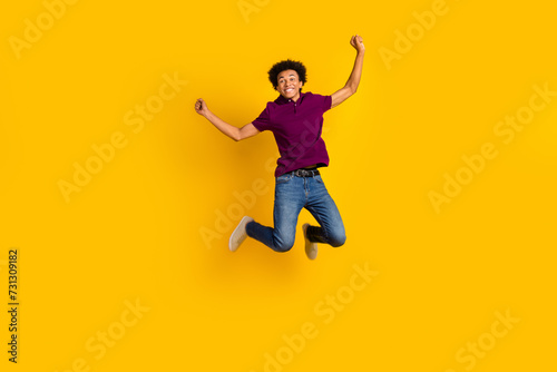 Full length photo of glad funny good mood guy wear trendy violet outfit rejoice special sale isolated on yellow color background