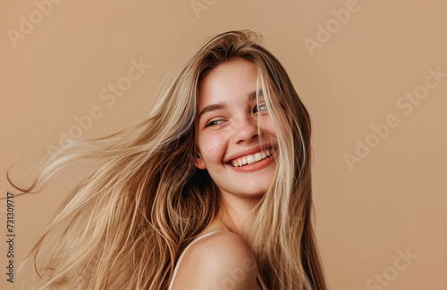 Beautiful smiling blonde woman with healthy shiny long hair