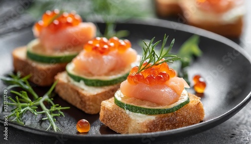 closeup of appetizers toast with salmon and lumpfish roe in a black plate lumpfish roe photo