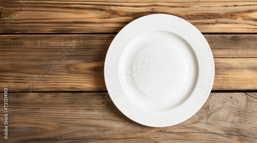 A minimalist white plate mockup resting on a rustic wooden table, awaiting delectable culinary presentation ideas. The clean surface of the plate offers endless possibilities for showcasing