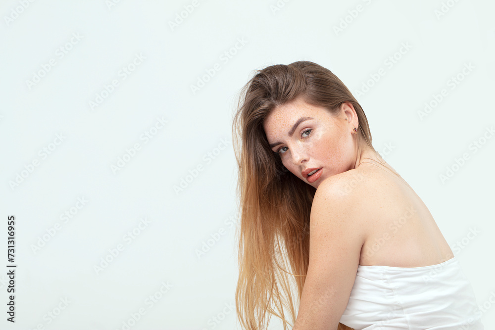 Natural caucasian ginger woman with freckles and clean healthy skin.